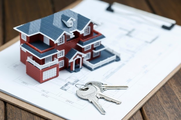 small house figurine with keys on a table